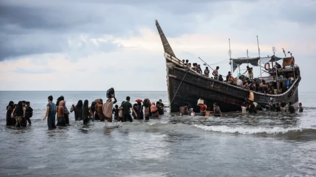 File image: Newly arrived Rohingya refugees return to a boat after the local community decided to temporarily allow them to land for water and food in Ulee Madon, Aceh province, Indonesia, on November